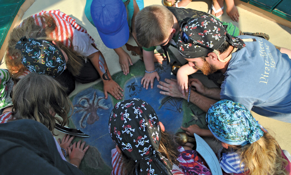 Kids looking at map on the Sea Gypsy, Pirate Adventures.