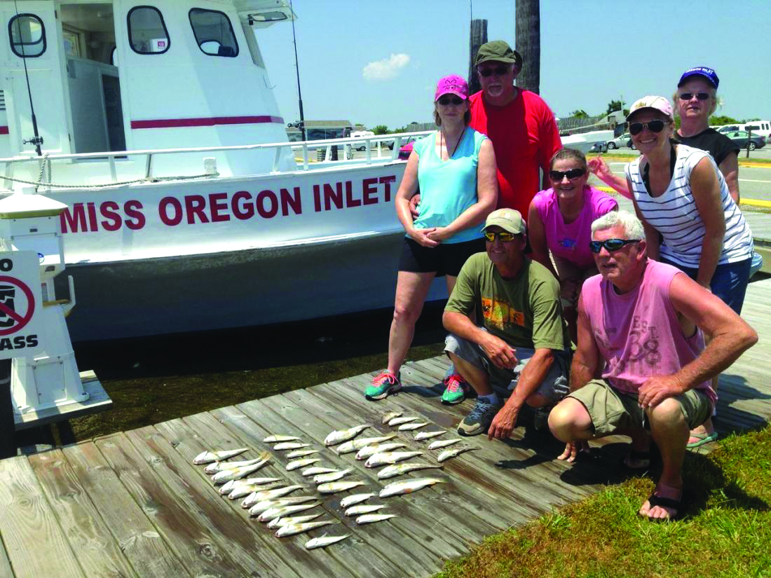 Family with their fish on Miss Oregon Inlet