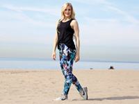 Stylish woman on beach modeling activewear