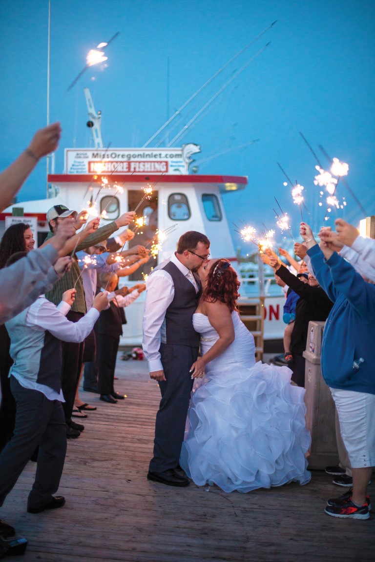 Couple kissing during Miss Oregon Inlet wedding reception