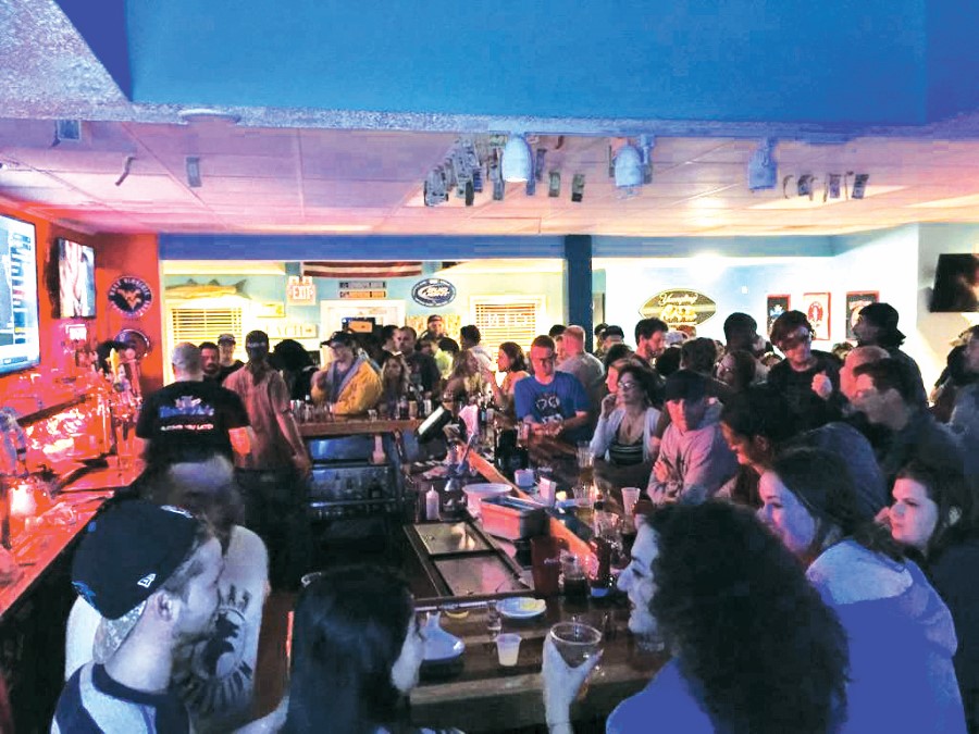 Guests gathered around the bar at Uncle Ike's in Corolla