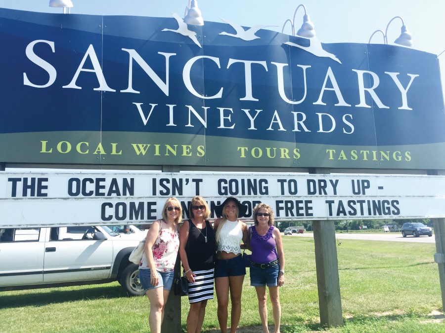 A family poses happily in front of Sanctuary Vineyards