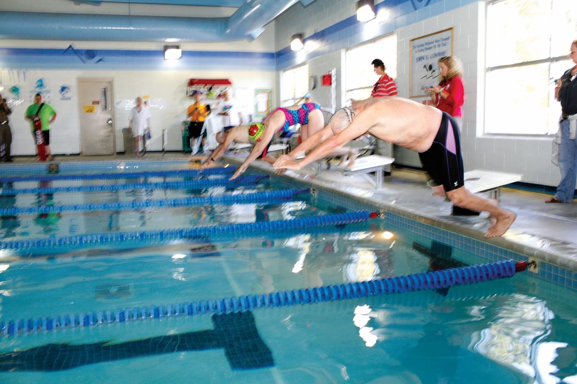 Swimmers diving into pool at the Outer Banks Family YMCA