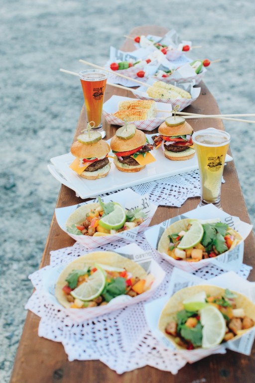 Outer Banks Brewing Station fish tacos, beer and mini burgers on picnic table