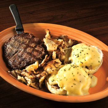 Steak with Poached Eggs on English Muffin topped with Hollandaise Sauce - served with grits, home fries or baked apples.