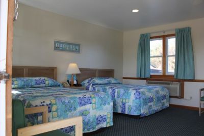 Room with two double beds at Pony Island Motel