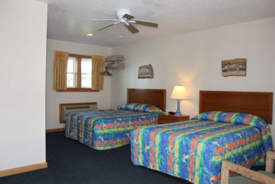 Room with two double beds at Pony Island Motel